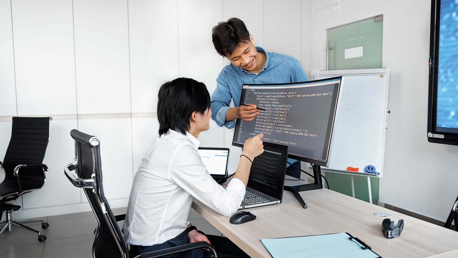 Recruiter comparing NetSuite partner and end-user job offers with a candidate across an office desk