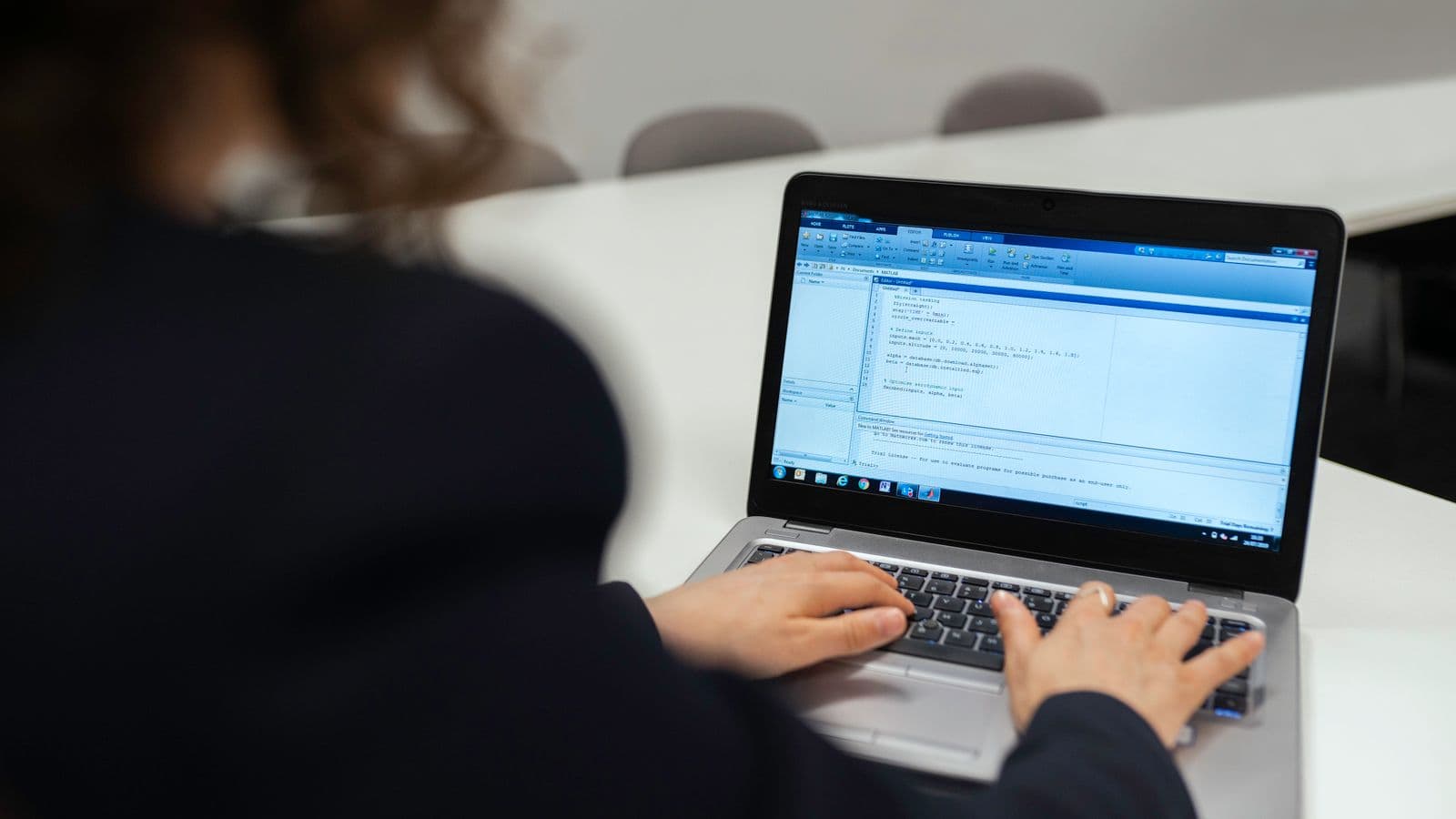 Odoo consultants weighing UK and US salary data from the 2026 pay guide in a team meeting