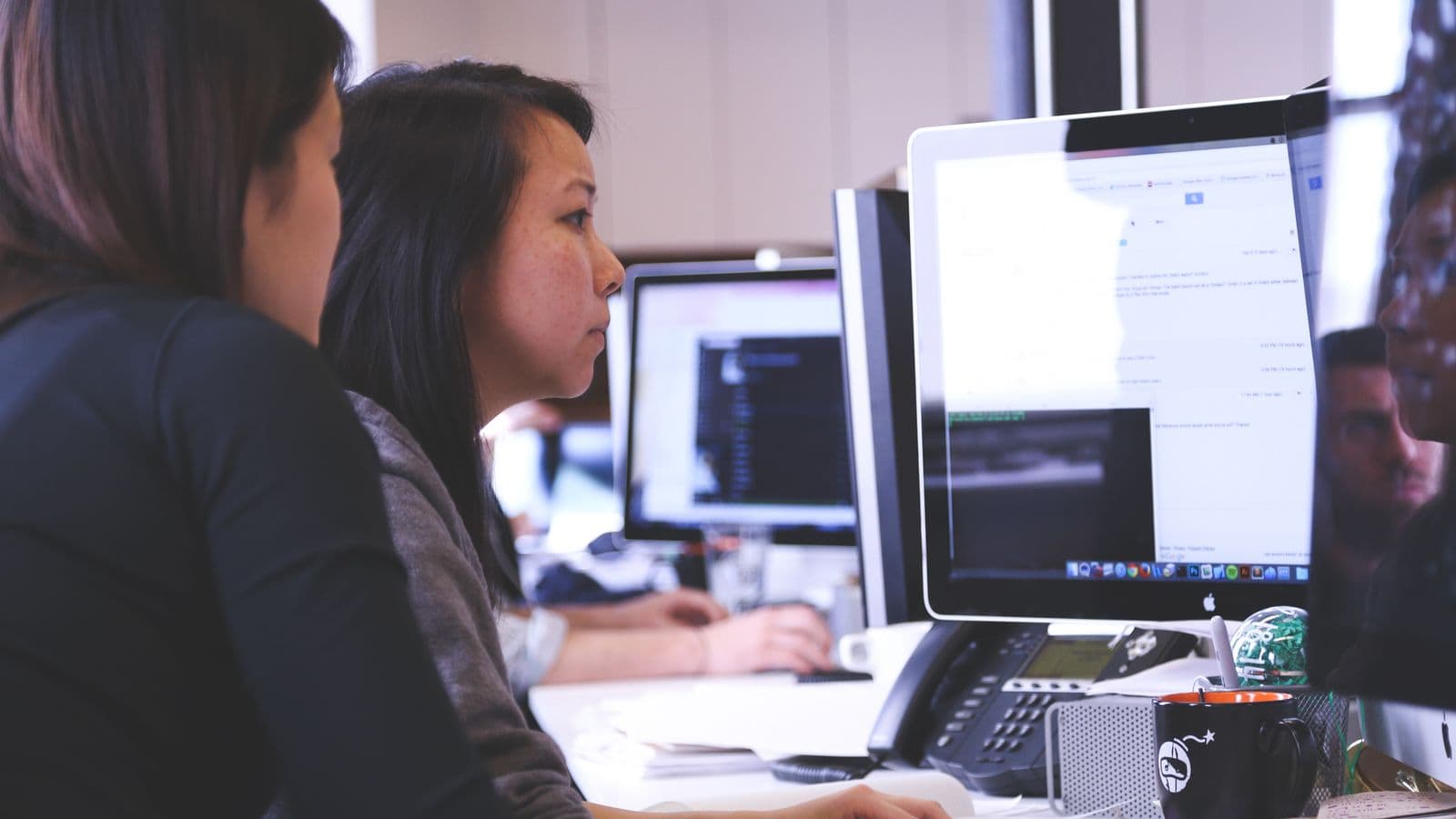Women technology professionals leading an ERP project discussion in a modern workplace